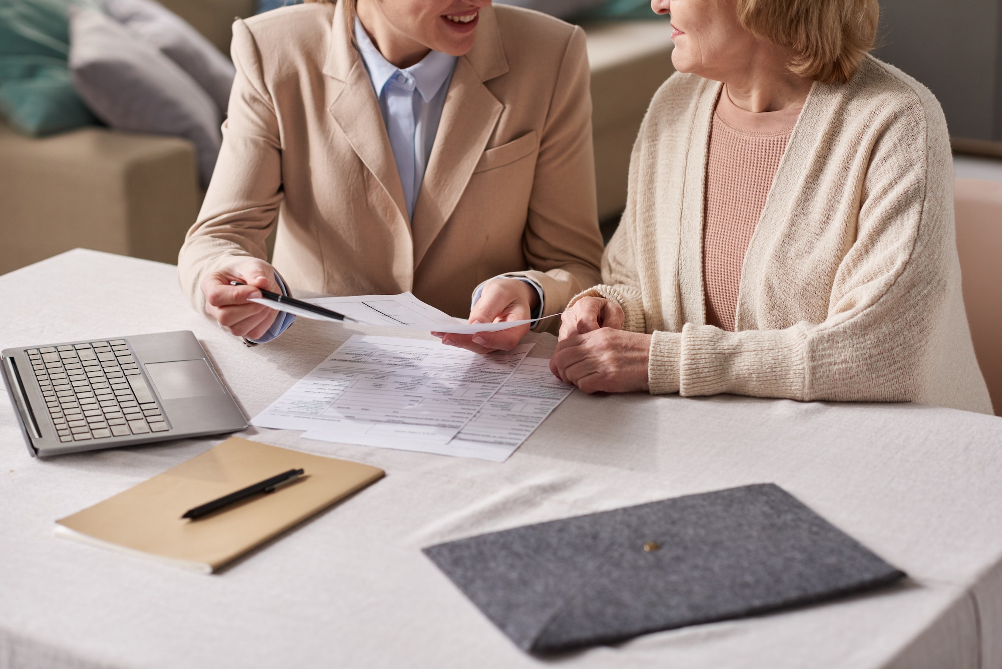 Businesswoman consulting senior woman about documents